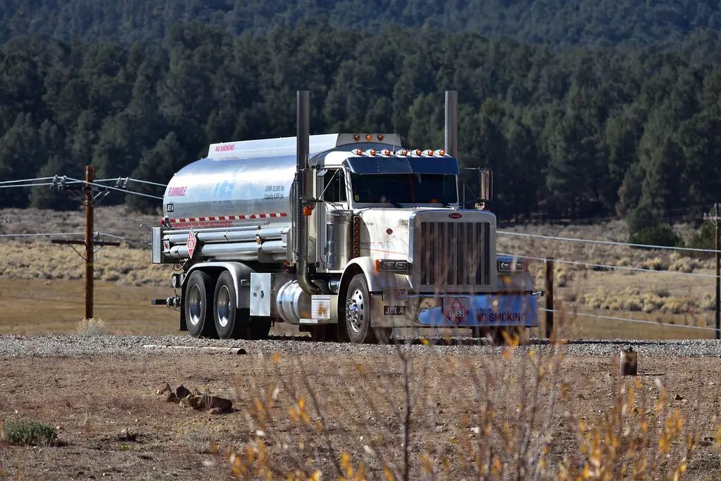 A fuel tanker truck on a rural highway